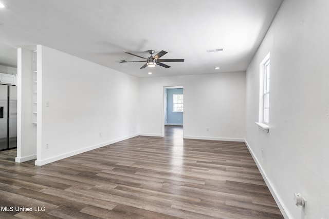 spare room featuring recessed lighting, visible vents, a ceiling fan, wood finished floors, and baseboards