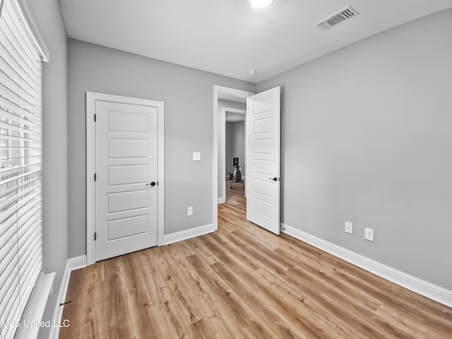 16814 W Landon Green Dr, Gulfport, MS 39503 - unfurnished bedroom with baseboards and light wood finished floors