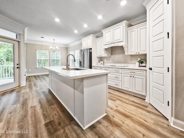 16814 W Landon Green Dr, Gulfport, MS 39503 - kitchen featuring ornamental molding, stainless steel refrigerator with ice dispenser, a chandelier, light wood finished floors, and light countertops