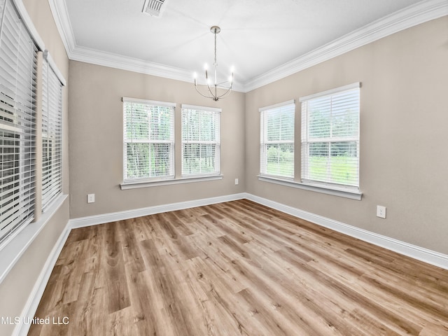 16814 W Landon Green Dr, Gulfport, MS 39503 - empty room featuring a chandelier, plenty of natural light, wood finished floors, and ornamental molding