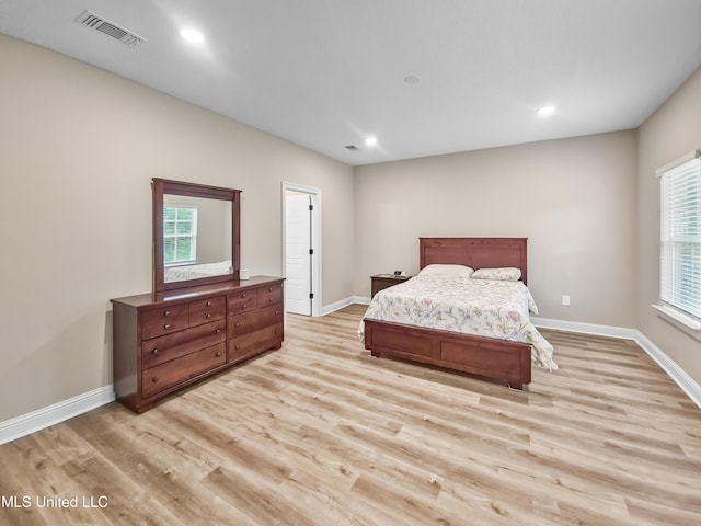 16814 W Landon Green Dr, Gulfport, MS 39503 - bedroom with light wood finished floors, multiple windows, and recessed lighting