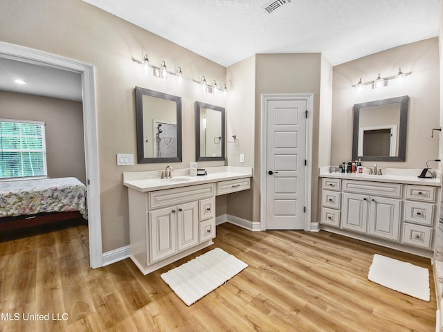 16814 W Landon Green Dr, Gulfport, MS 39503 - full bath featuring two vanities, wood finished floors, and ensuite bath