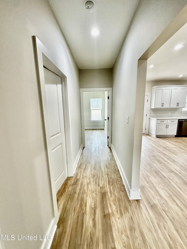 hallway with light hardwood / wood-style floors