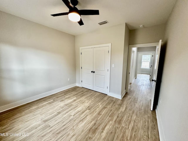 unfurnished bedroom with a closet, ceiling fan, and light hardwood / wood-style floors