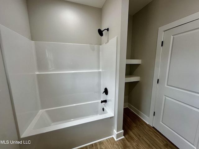 bathroom with hardwood / wood-style floors and  shower combination