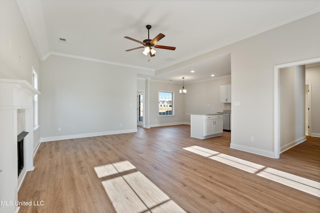 unfurnished living room with a fireplace, light wood finished floors, ceiling fan with notable chandelier, and ornamental molding