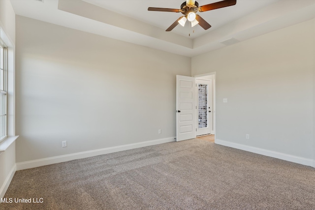 empty room with visible vents, ceiling fan, light colored carpet, and baseboards