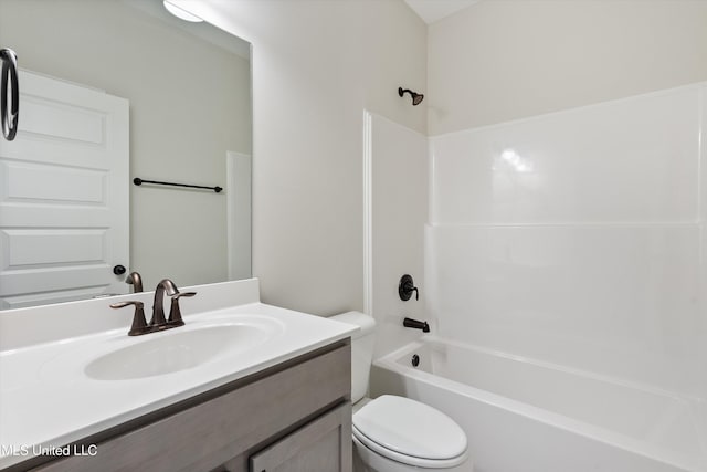 full bathroom featuring washtub / shower combination, vanity, and toilet