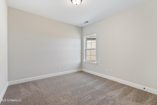 carpeted empty room with visible vents and baseboards