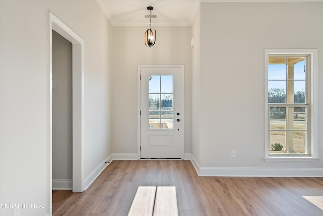 doorway to outside with a wealth of natural light, visible vents, baseboards, and wood finished floors