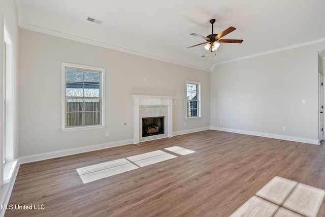 unfurnished living room featuring crown molding, visible vents, ceiling fan, and light wood finished floors