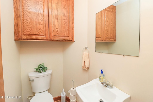 half bathroom with toilet and a sink