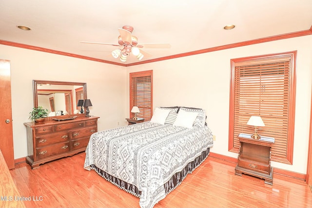 bedroom with crown molding, baseboards, and wood finished floors