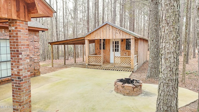 view of patio with an outbuilding and an outdoor fire pit