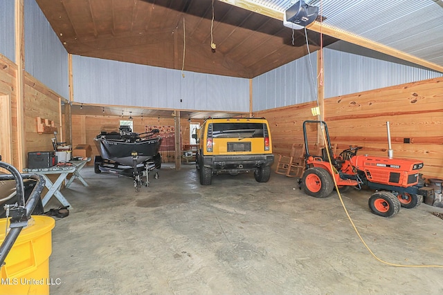 garage featuring a garage door opener and metal wall