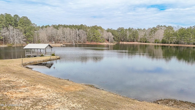 dock area featuring a water view and a wooded view