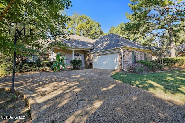 ranch-style home featuring a front lawn and a garage