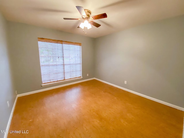 empty room featuring ceiling fan and hardwood / wood-style floors