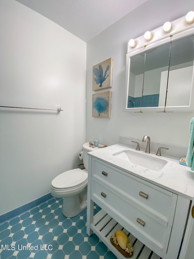 bathroom featuring toilet and vanity