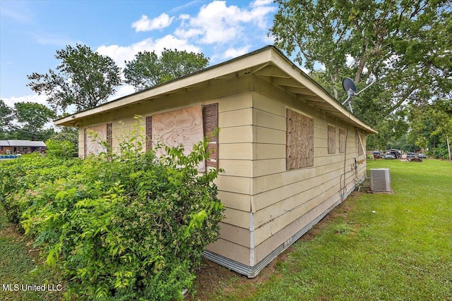 view of property exterior with cooling unit and a yard