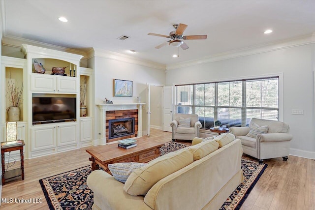 105 Speers Valley Rd, Brandon, MS 39042 - living room featuring a ceiling fan, light wood-type flooring, a tile fireplace, ornamental molding, and recessed lighting