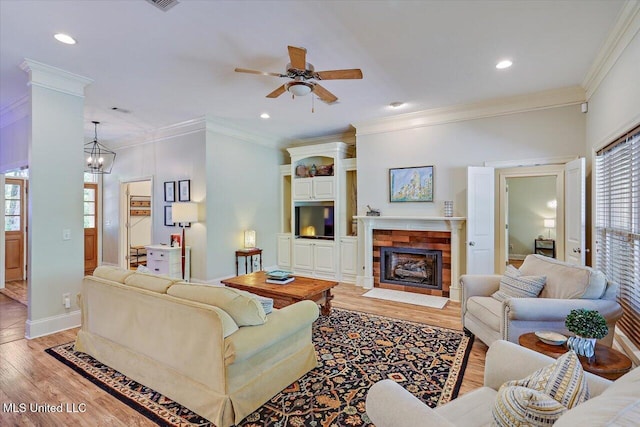 105 Speers Valley Rd, Brandon, MS 39042 - living room featuring light wood-style flooring, a tiled fireplace, a ceiling fan, ornamental molding, and recessed lighting