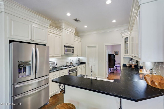 105 Speers Valley Rd, Brandon, MS 39042 - kitchen with appliances with stainless steel finishes, decorative backsplash, glass insert cabinets, dark countertops, and crown molding