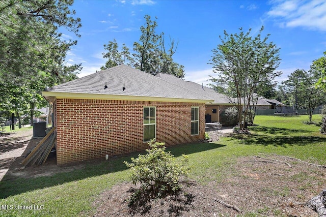 105 Speers Valley Rd, Brandon, MS 39042 - rear view of house with central AC unit, a shingled roof, and brick siding