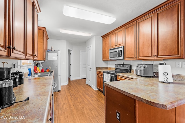 kitchen featuring light wood-type flooring, sink, and black electric range oven