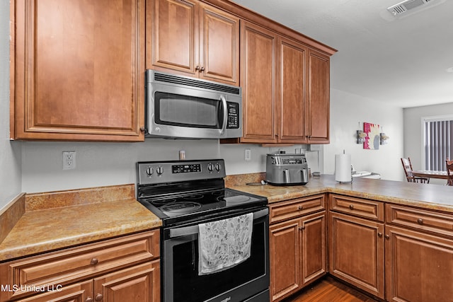 kitchen featuring appliances with stainless steel finishes and wood-type flooring