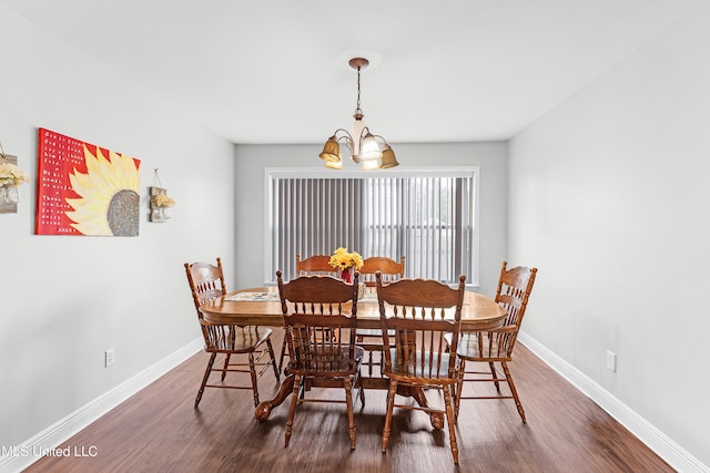 dining room with a chandelier and dark hardwood / wood-style flooring