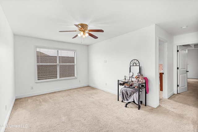 unfurnished room with light colored carpet and ceiling fan