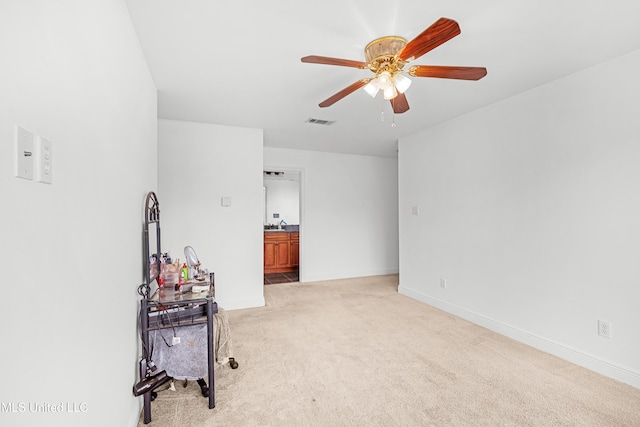 carpeted empty room featuring ceiling fan