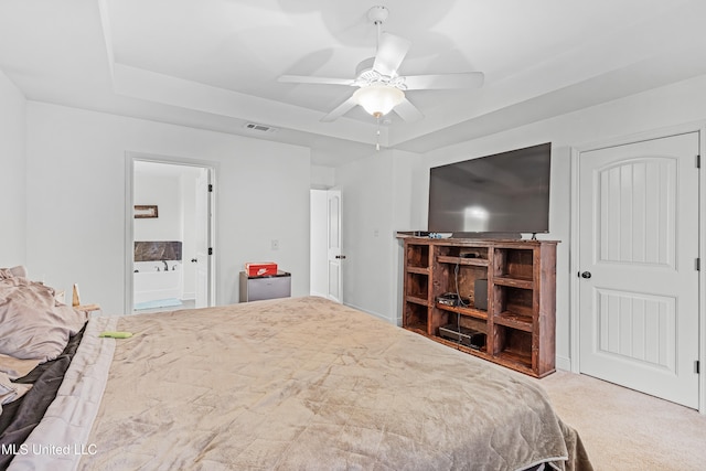 bedroom with ceiling fan, connected bathroom, and carpet