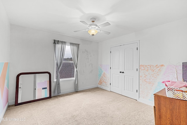 interior space with light colored carpet and ceiling fan