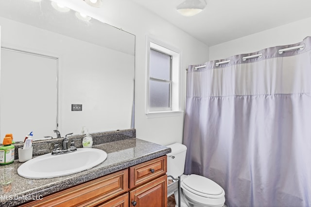 bathroom featuring vanity and toilet