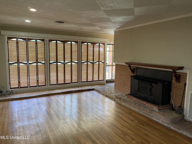 2136 Attala Rd Unit 5247, Kosciusko, MS 39090 - unfurnished living room with ornamental molding, wooden walls, and wood finished floors
