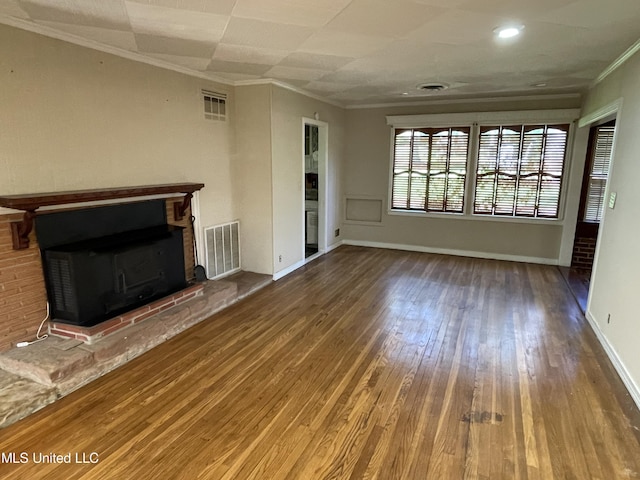 2136 Attala Rd Unit 5247, Kosciusko, MS 39090 - unfurnished living room featuring a fireplace, ornamental molding, hardwood / wood-style floors, and visible vents