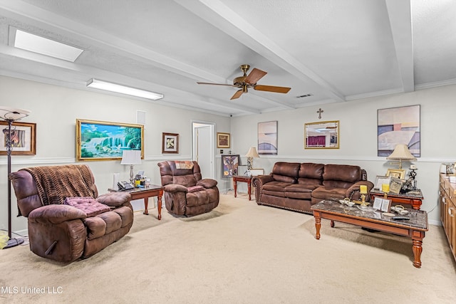 living room with beamed ceiling, light colored carpet, and ceiling fan