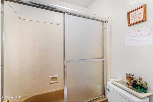 bathroom featuring toilet and enclosed tub / shower combo