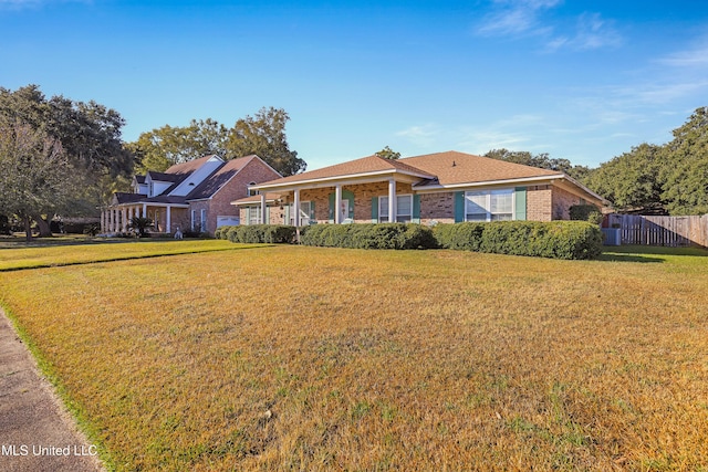 ranch-style home with a front lawn