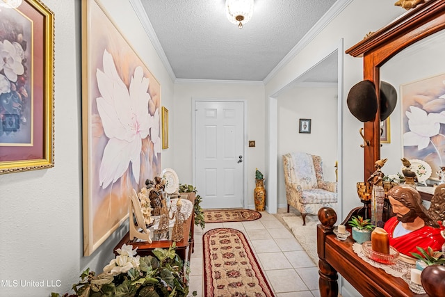 entryway featuring light tile patterned floors, a textured ceiling, and ornamental molding