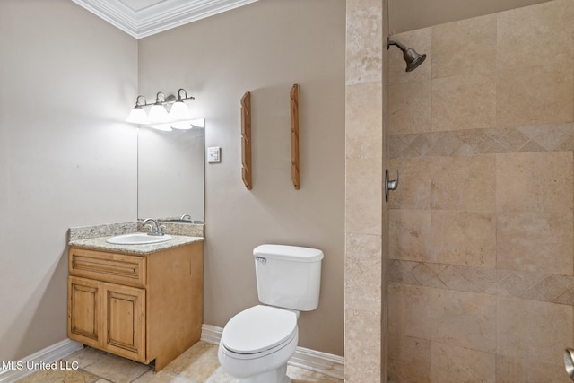 bathroom featuring baseboards, tiled shower, toilet, crown molding, and vanity