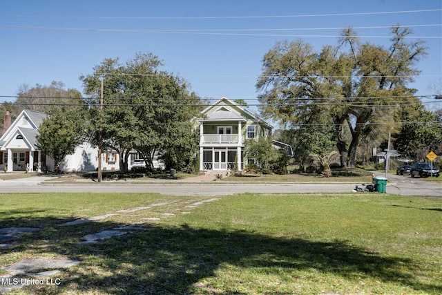 view of yard with a balcony