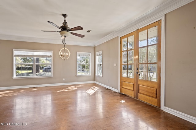 doorway featuring a healthy amount of sunlight, wood-type flooring, and crown molding