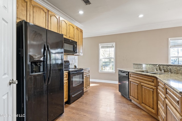 kitchen with a healthy amount of sunlight, crown molding, and black appliances