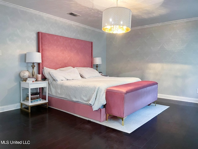 bedroom featuring ornamental molding, dark wood-type flooring, and a notable chandelier