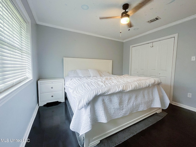 bedroom featuring a closet, ceiling fan, and ornamental molding