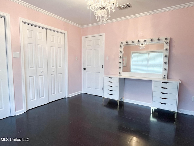 interior space featuring ornamental molding, a notable chandelier, and dark hardwood / wood-style flooring