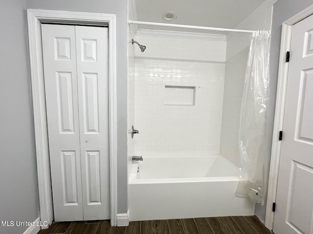 bathroom featuring hardwood / wood-style floors and shower / tub combo with curtain